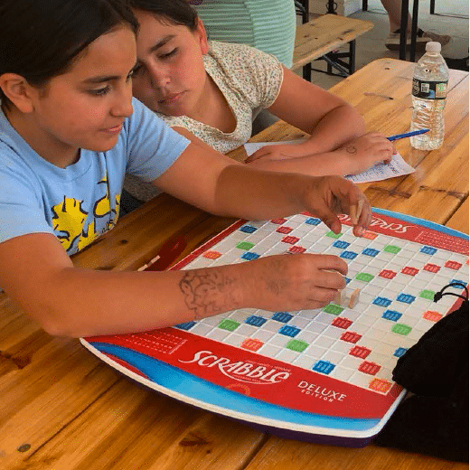 Children learning scrabble